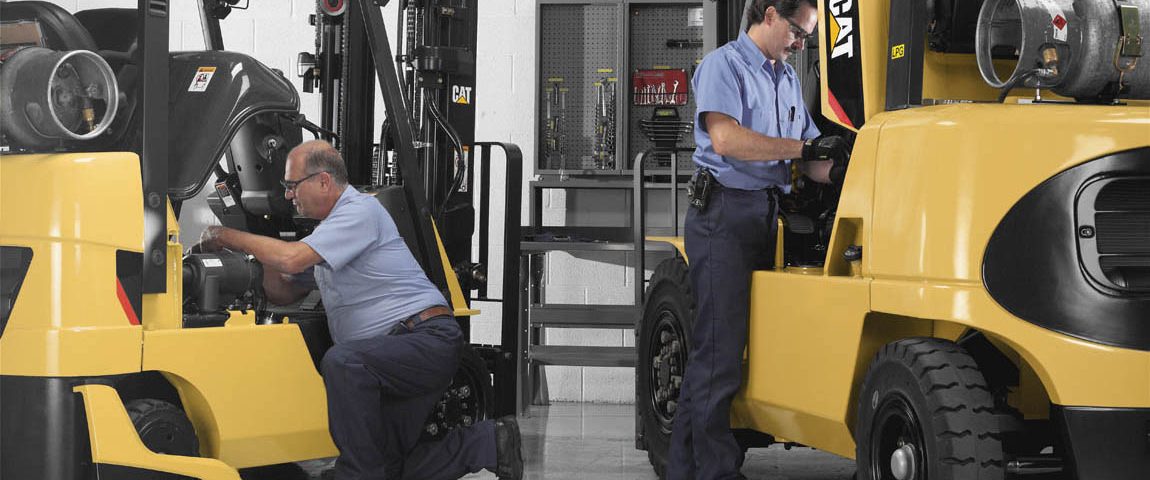 Employees servicing CAT forklifts
