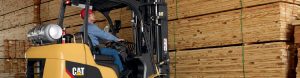 Employee operating forklift with wood slats banner