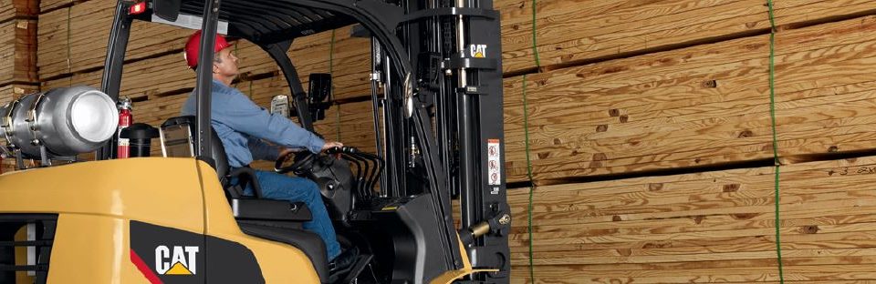 Employee operating forklift with wood slats banner