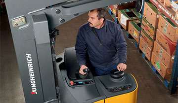 Jungheinrich ETR forklift stocking shelves in a warehouse.