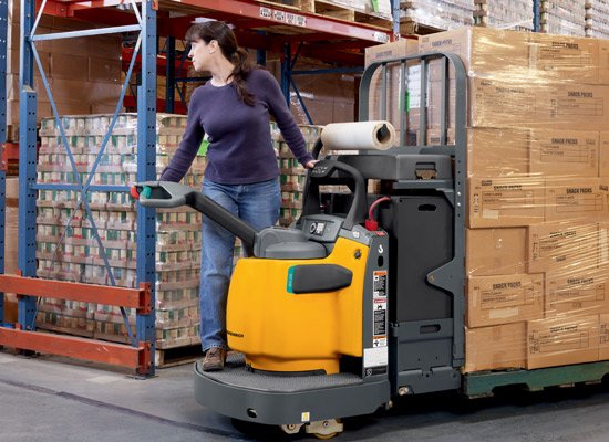 Female operating a Jungheinrich ECR 327/336 electric pallet jack.