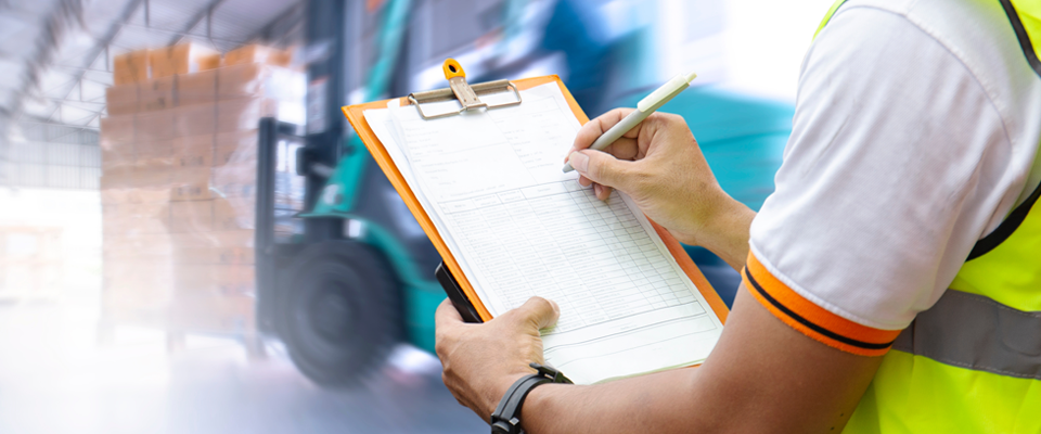 Warehouse worker reviewing checklist