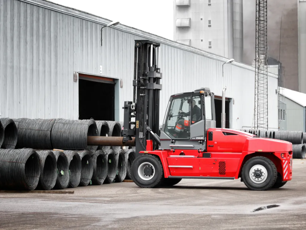 KALMAR DCG160-12 Diesel Pneumatic Truck picking up steel